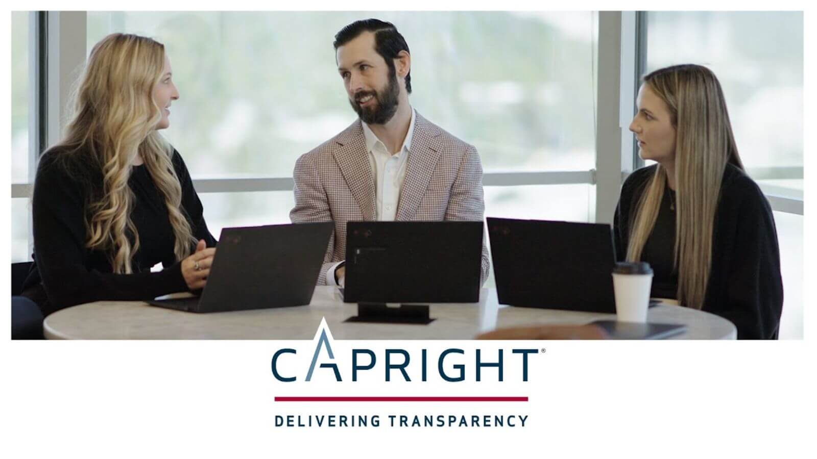 3 capright people sitting at a table talking