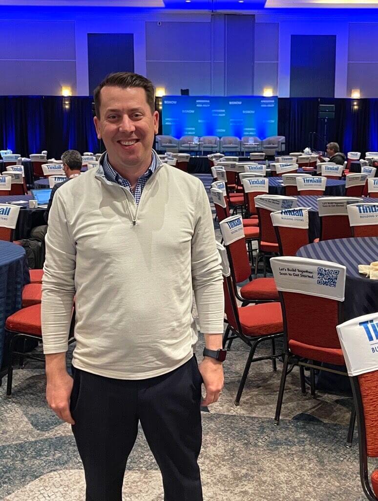 Steve Lore standing in front of conference tables